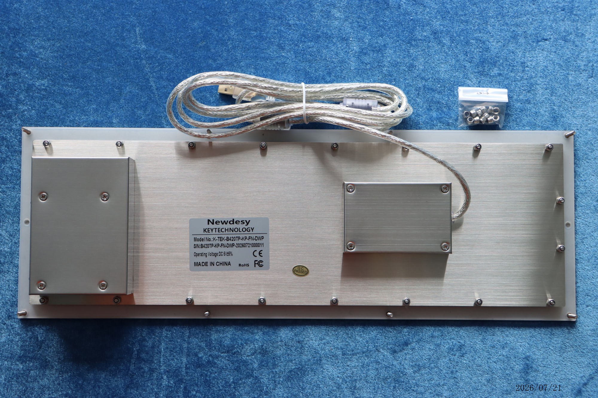 Rear view of the Newdesy K-TEK-B420TP-KP-FN-DWP showing threaded mounting studs, enclosures and USB cable